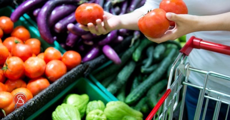 Grocery shopper plans meals and chooses food wisely while practice mindful eating for healthier life. Surgical Association of Mobile logo at bottom left.