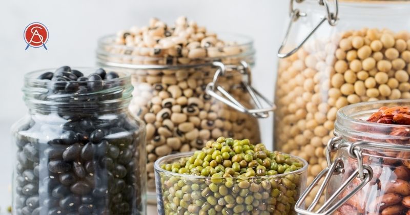 Dry beans in jars represent healthy carbohydrates for weight loss and maintenance. Surgical Association of Mobile logo at top right.