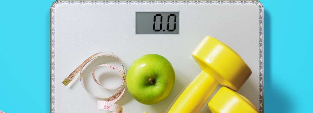 scale with dumbbells, measuring tape, apple 