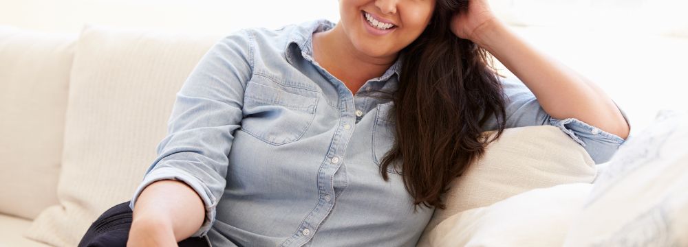 Woman sitting on couch smiling 