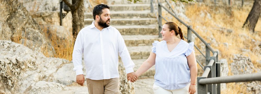 Couple walking while looking at each other and smiling 